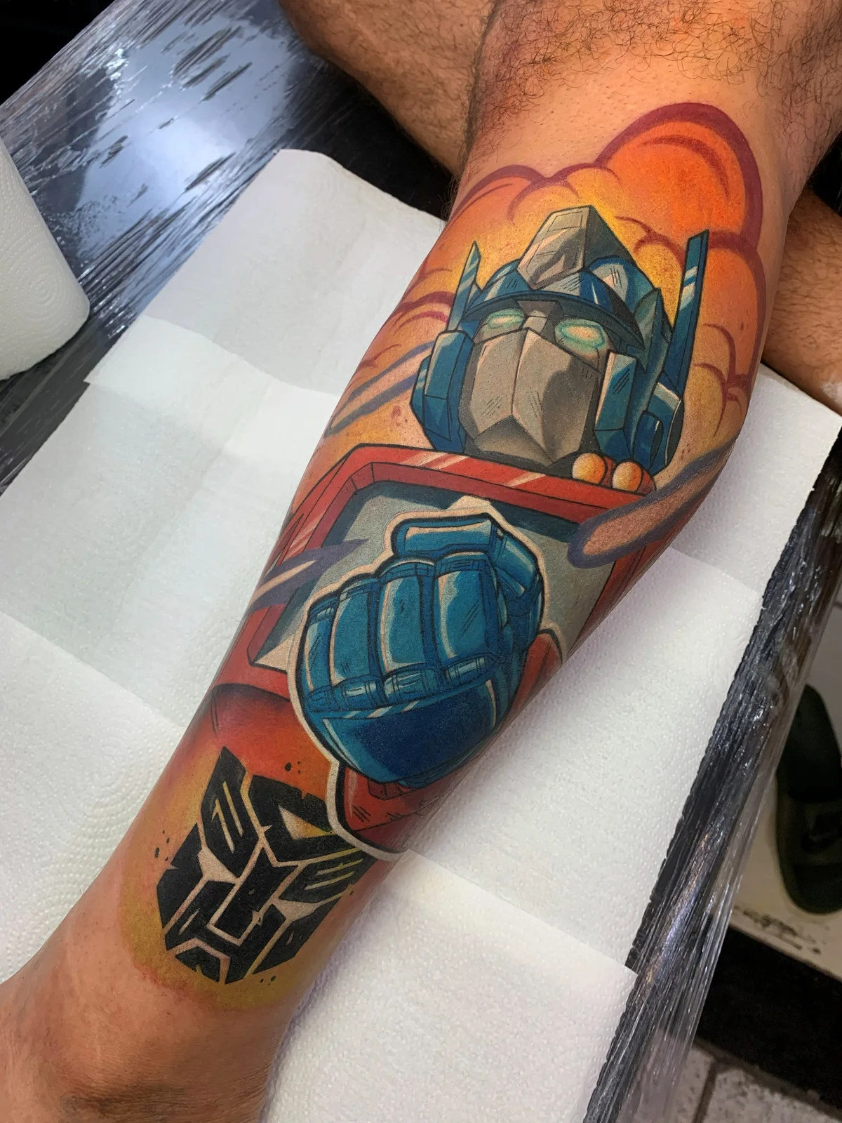 Colorful tattoo of Optimus Prime, from Transformers, on the leg