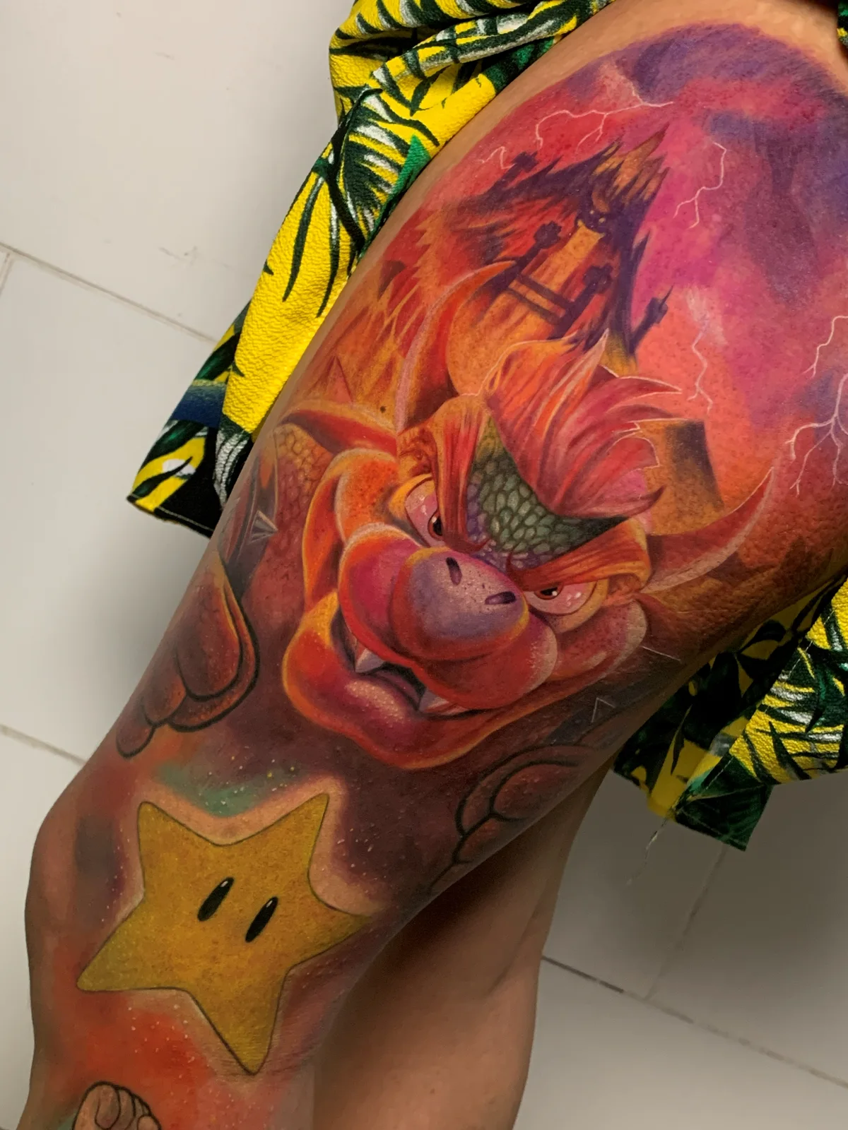 Colorful Dragon Ball tattoo with a Mario star on the leg