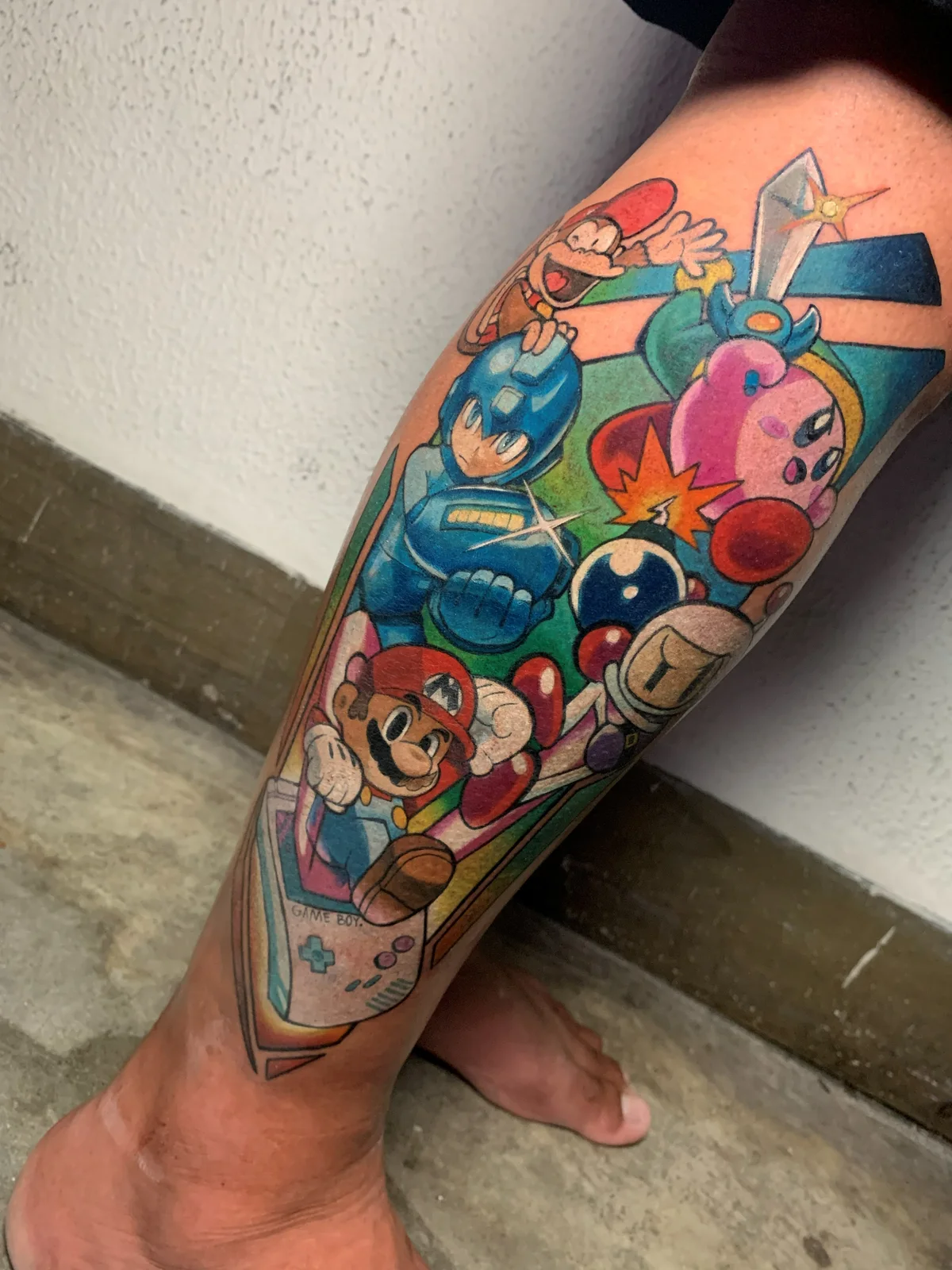 Colorful Nintendo characters tattoo on the leg